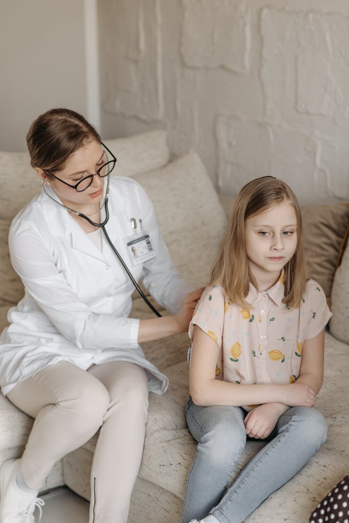 A doctor conducts a health checkup for a young girl at home, ensuring comfort and care.